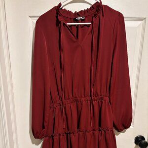 Cranberry-colored short dress with ruffle bottom and ruffle neck.